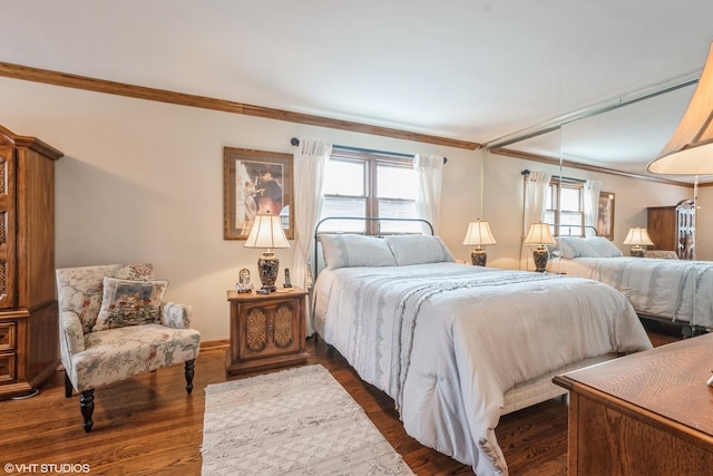 bedroom with crown molding and dark wood finished floors