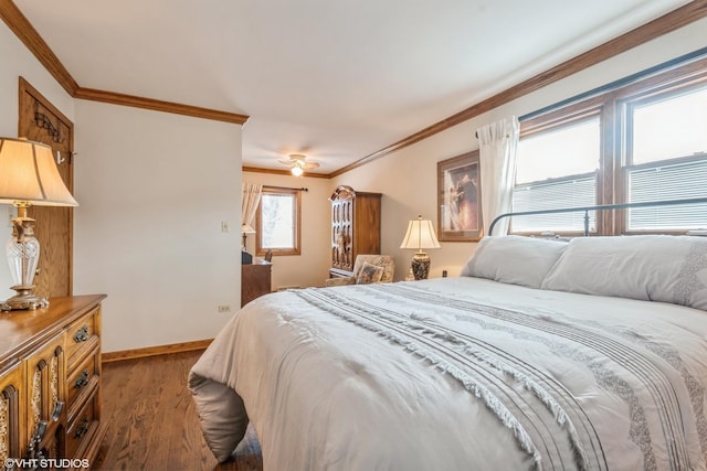 bedroom featuring ornamental molding, dark wood finished floors, baseboards, and a ceiling fan