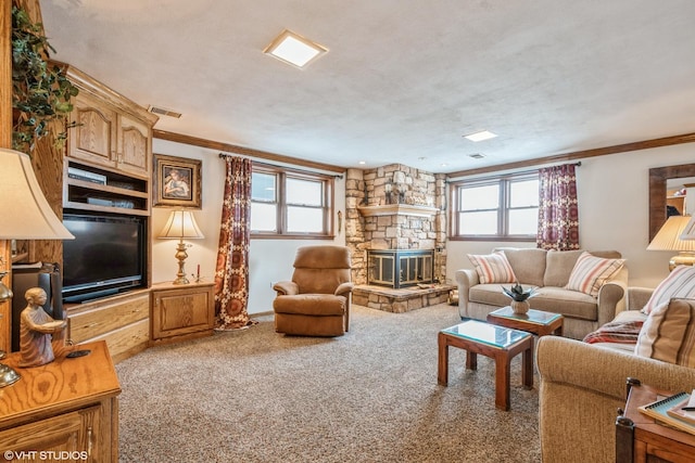 living area with carpet floors, plenty of natural light, and ornamental molding