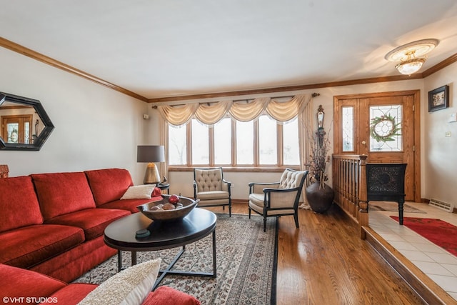 living room featuring a wealth of natural light, visible vents, crown molding, and wood finished floors