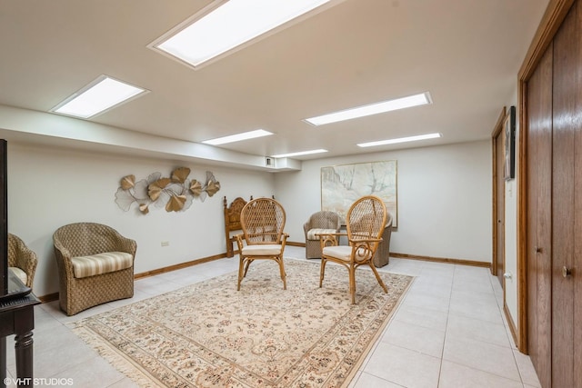 sitting room with light tile patterned flooring and baseboards