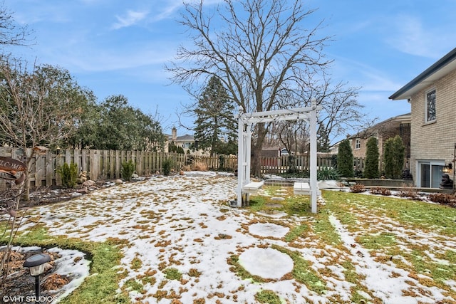 yard covered in snow with fence