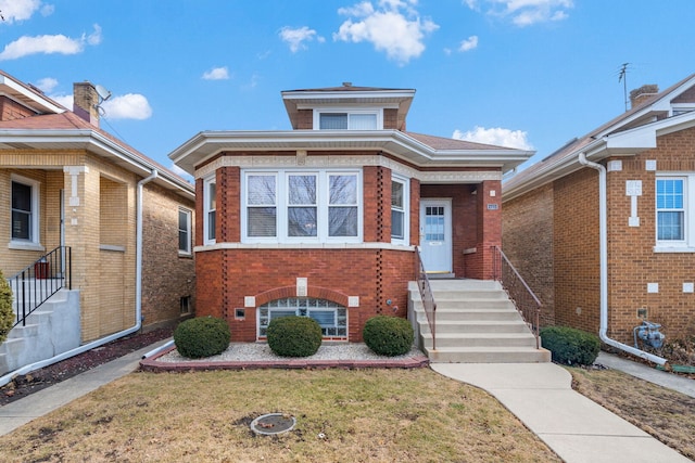 view of front facade with brick siding and a front yard