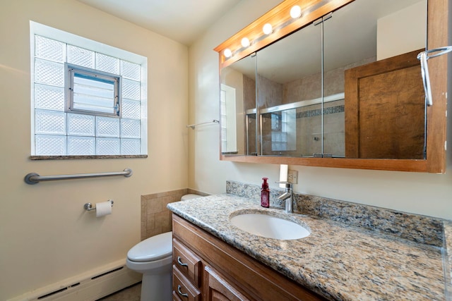 bathroom with toilet, a stall shower, a baseboard radiator, and vanity