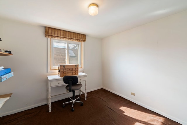 unfurnished office featuring carpet flooring and baseboards