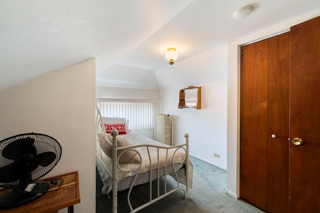 carpeted bedroom with vaulted ceiling and baseboards