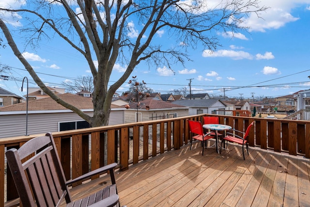 wooden deck featuring a residential view and outdoor dining area