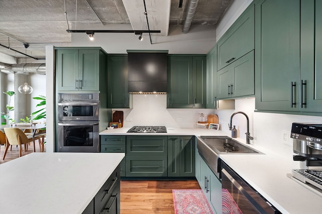 kitchen with light countertops and green cabinetry