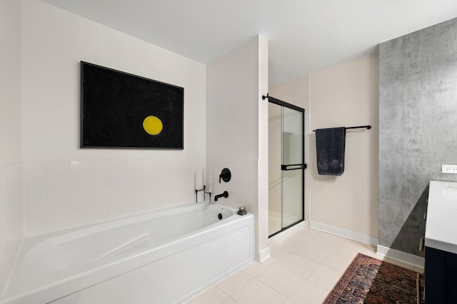 bathroom with tile patterned flooring, vanity, baseboards, a bath, and a stall shower