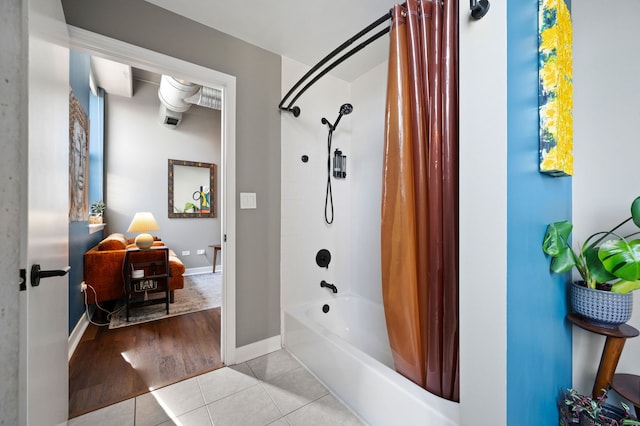 bathroom featuring shower / tub combo, baseboards, and tile patterned floors