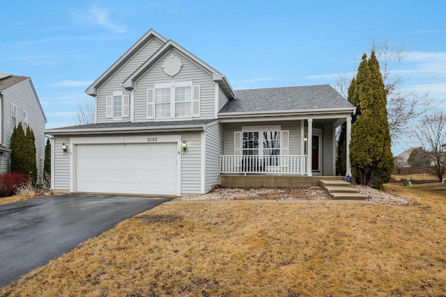 traditional home with a garage, driveway, a porch, and roof with shingles