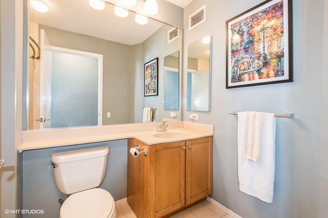 bathroom with visible vents, vanity, and toilet