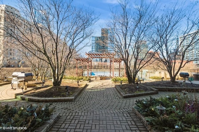 view of home's community with a pergola and a patio