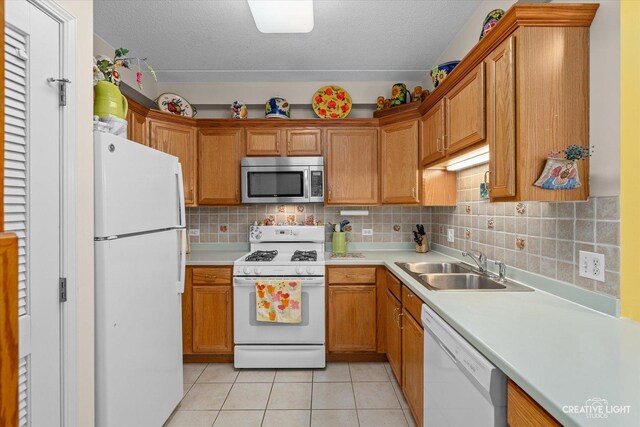 420 W Burlington Ave Unit 303, La Grange, IL 60525 - kitchen featuring white appliances, a sink, light countertops, a textured ceiling, and light tile patterned floors