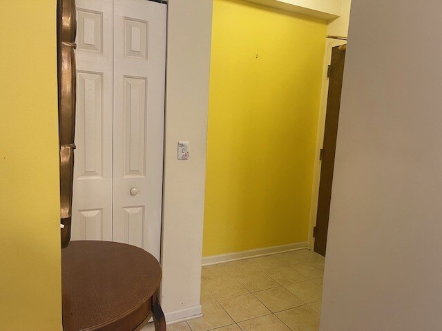 420 W Burlington Ave Unit 303, La Grange, IL 60525 - hallway with light tile patterned floors and baseboards
