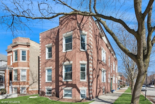 view of front of house featuring brick siding