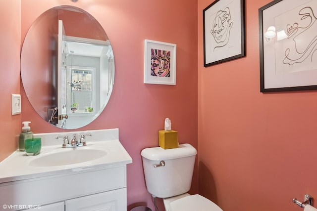 half bathroom featuring toilet and vanity