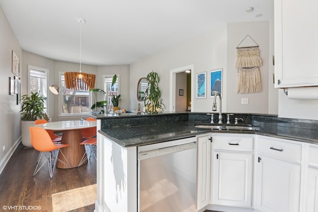 kitchen with a sink, dishwasher, a peninsula, and white cabinetry