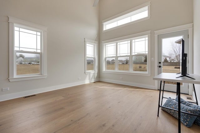 unfurnished sunroom featuring visible vents