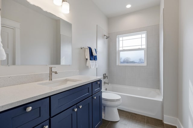 full bath featuring vanity, tile patterned flooring, shower / tub combination, and toilet