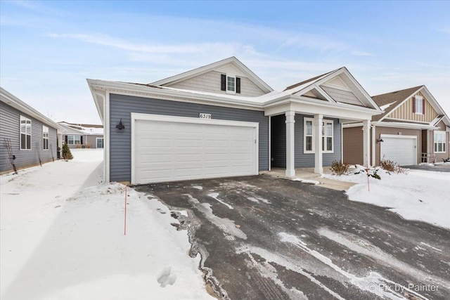 view of front of property with an attached garage and aphalt driveway