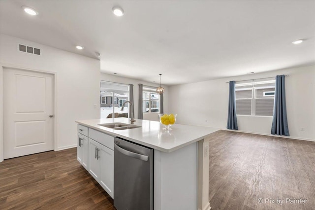 kitchen featuring light countertops, stainless steel dishwasher, white cabinetry, a sink, and an island with sink