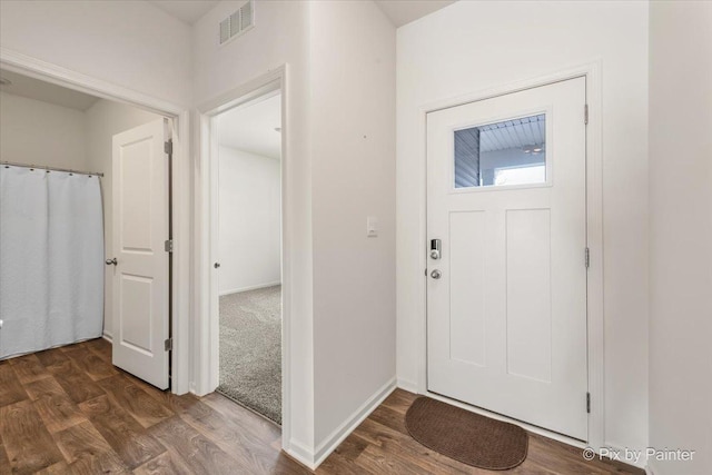 entrance foyer with visible vents, dark wood finished floors, and baseboards