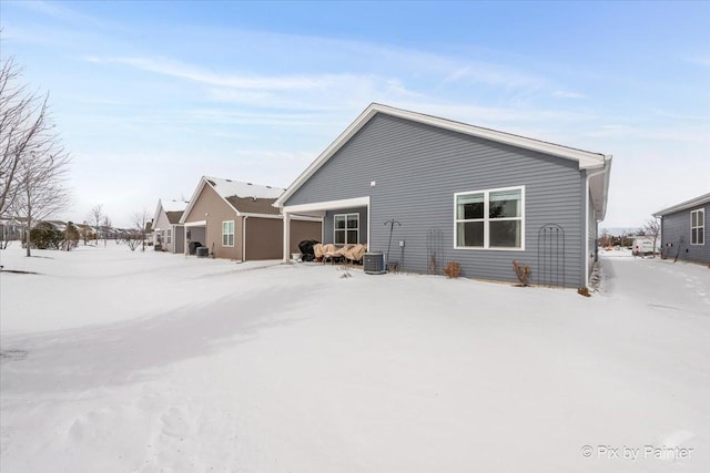 view of snow covered rear of property