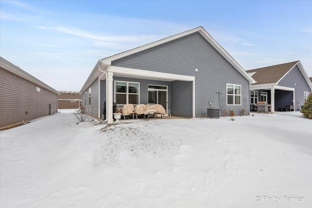 view of snow covered back of property