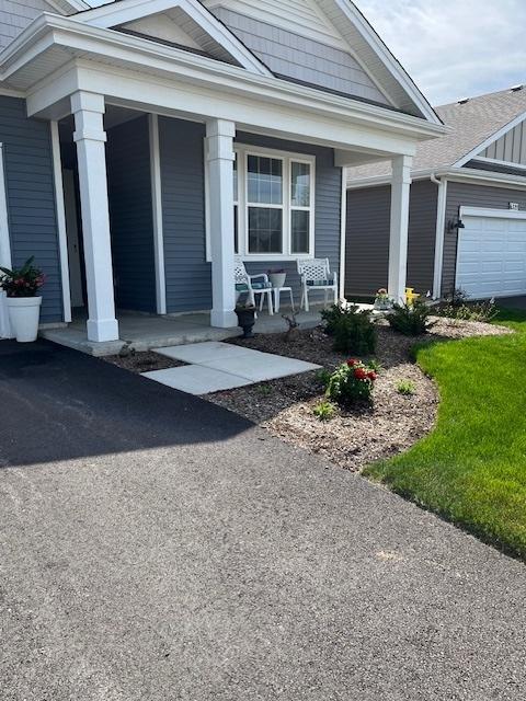 view of front of house featuring a porch and an attached garage