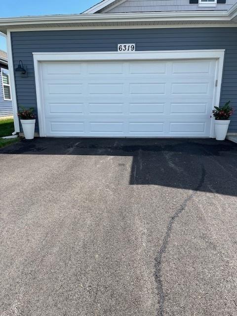 garage with aphalt driveway