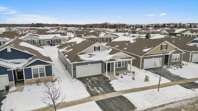 snowy aerial view featuring a residential view