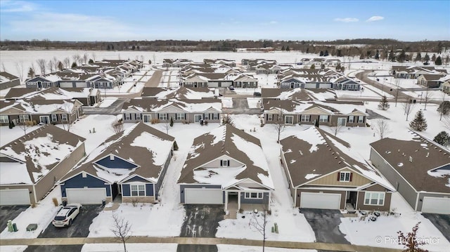 snowy aerial view featuring a residential view