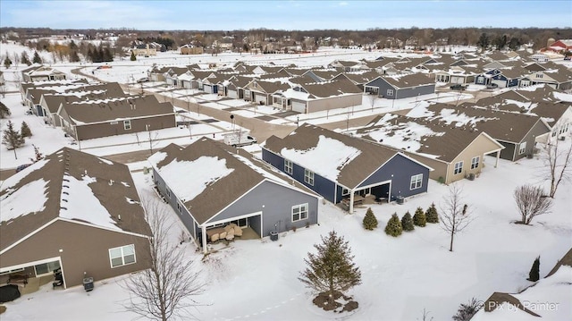 snowy aerial view with a residential view