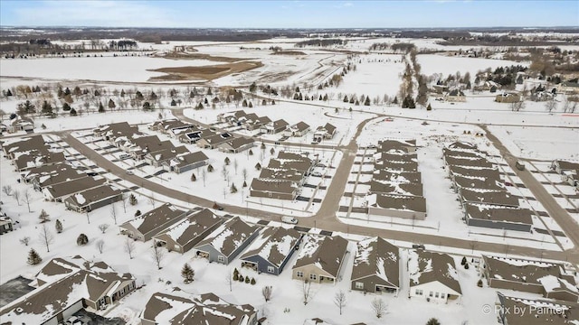 snowy aerial view with a residential view