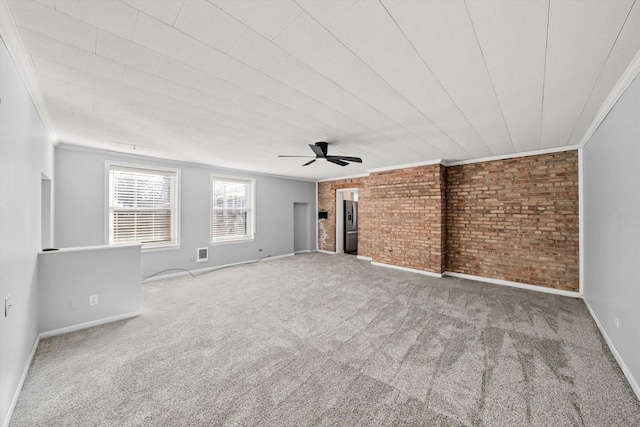 unfurnished living room with brick wall, a ceiling fan, baseboards, carpet, and crown molding