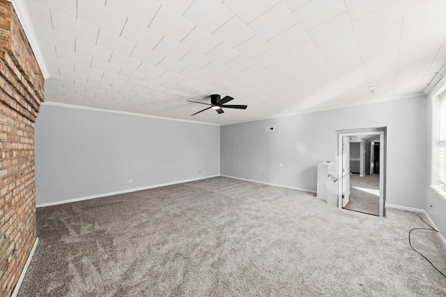 interior space with ornamental molding, carpet flooring, baseboards, and a ceiling fan