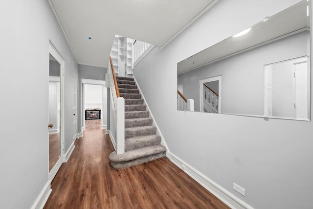 stairs featuring baseboards and wood finished floors