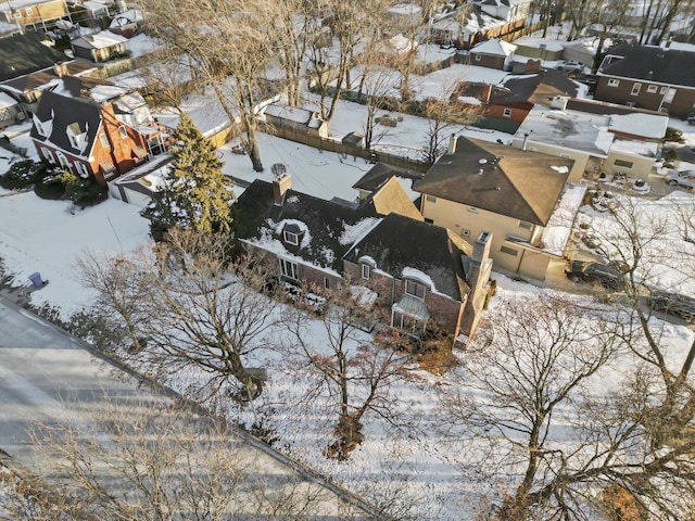 snowy aerial view featuring a residential view