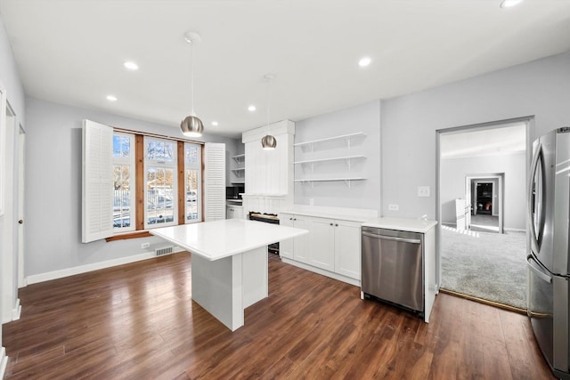 kitchen with appliances with stainless steel finishes, hanging light fixtures, light countertops, white cabinetry, and open shelves