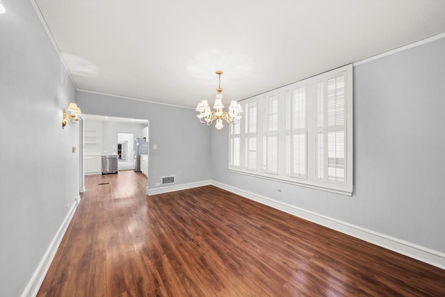 unfurnished dining area with visible vents, baseboards, ornamental molding, dark wood-type flooring, and a notable chandelier