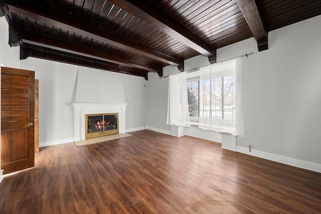 unfurnished living room with wood ceiling, baseboards, wood finished floors, and a glass covered fireplace