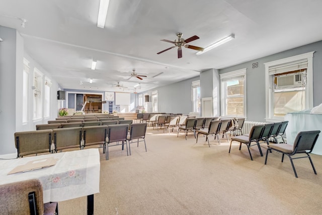 interior space with light carpet and ceiling fan