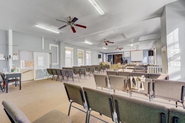 dining room featuring a ceiling fan and light carpet