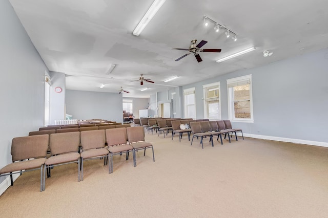 dining area with carpet, ceiling fan, and baseboards