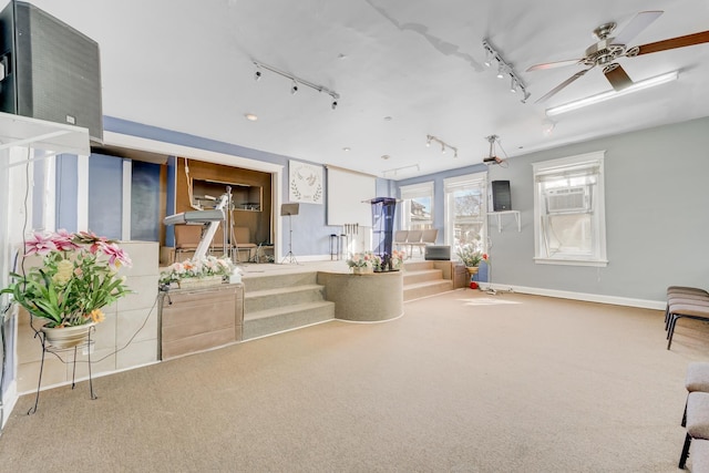 interior space featuring a ceiling fan, cooling unit, baseboards, and track lighting