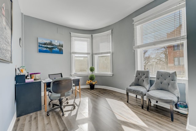 office area with light wood-type flooring and baseboards