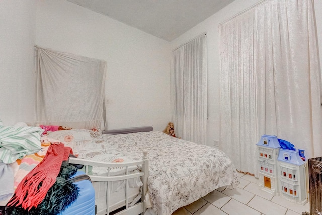 bedroom with light tile patterned floors