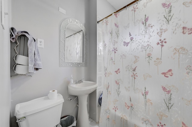 bathroom featuring shower / tub combo, a sink, and toilet