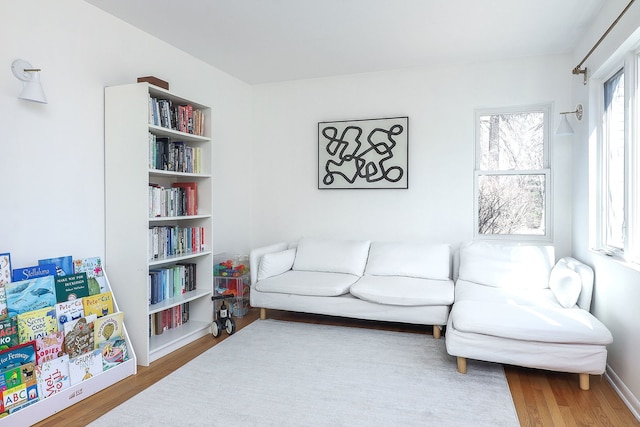 living area featuring baseboards and wood finished floors